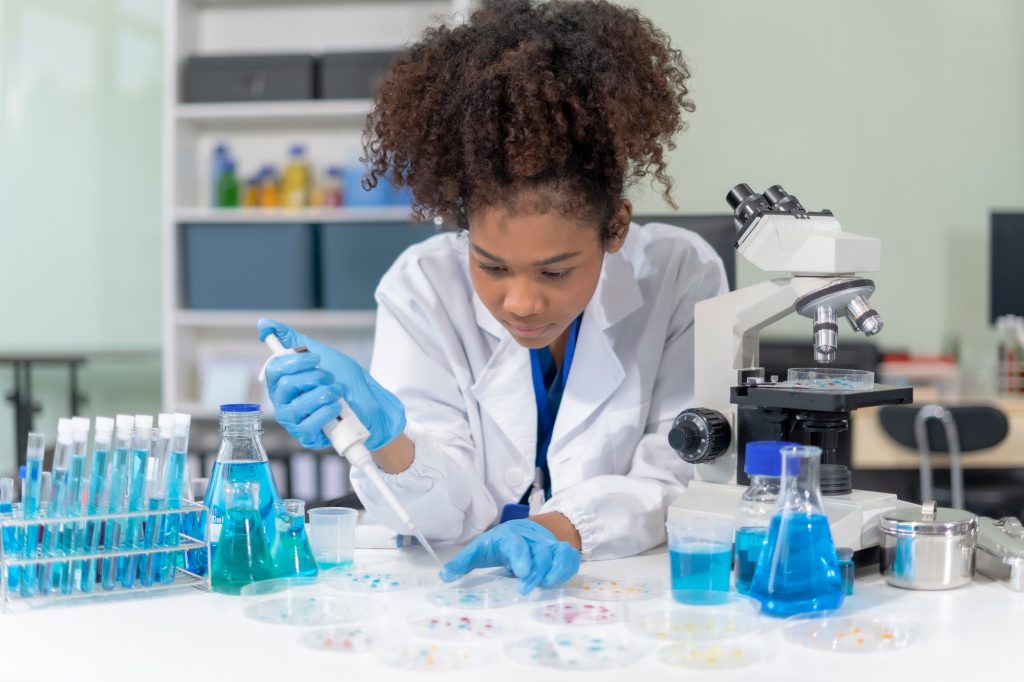 Scientist mixing chemical liquids in the chemistry lab.